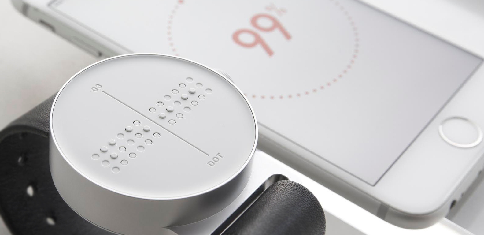 Dot Watch displaying loading info from a phone screen in Braille